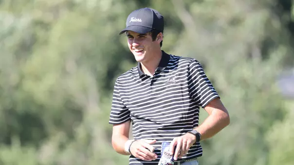 Men's golf player Callan Fahey laughing on the course