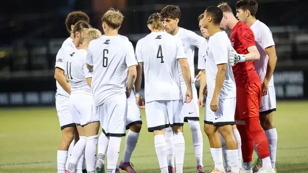 Mens Soccer Huddles before game against Bryant.