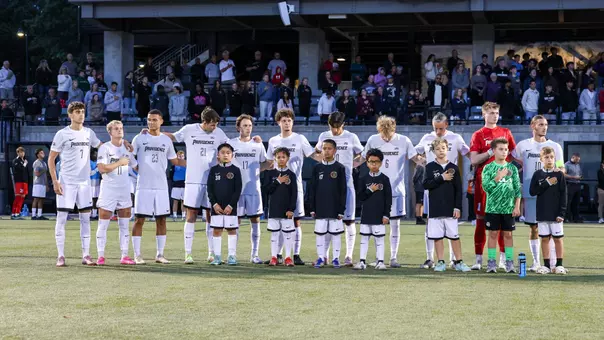 Men's Soccer team stands together during the National Anthem