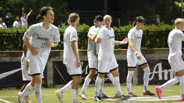 Men's Soccer celebrates a goal together against Boston College at home.