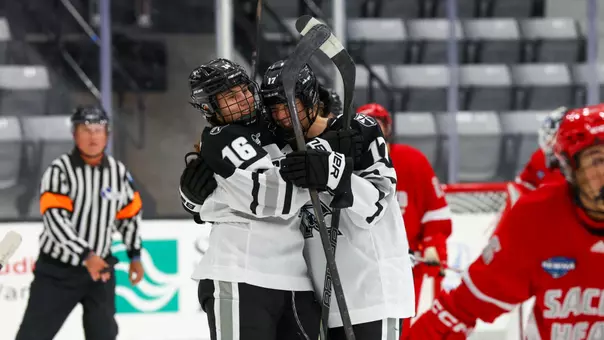 Women's ice hockey players Reichen Kirchmair and Bella Paolucci celebrating a goal