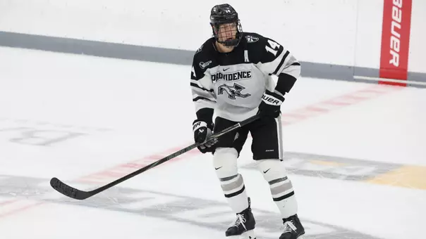 Men's hockey's Aleksi Kivioja skates in the neutral zone during a game at Schneider Arena