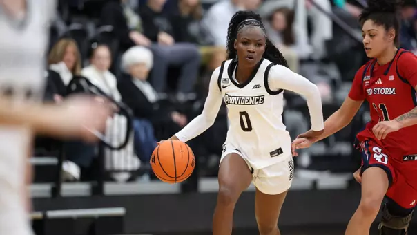 Sabou Gueye dribbling down the court past a St. John's defender during a BIG East game at Alumni Hall in Providence, R.I.