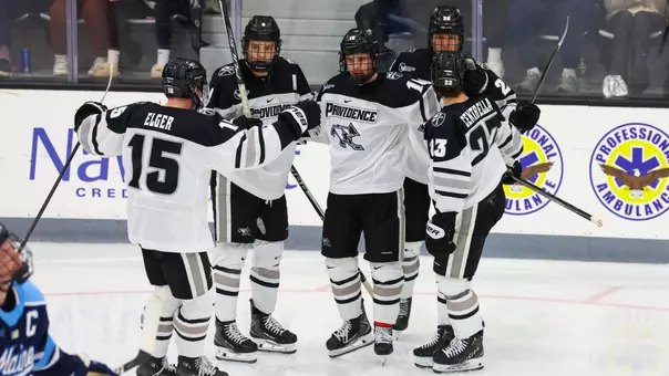 Men's Hockey team celebrates a goal against Maine. Will Elger, Hudson Malinoski, Julius Sumpf and Andrew Centrella pictured