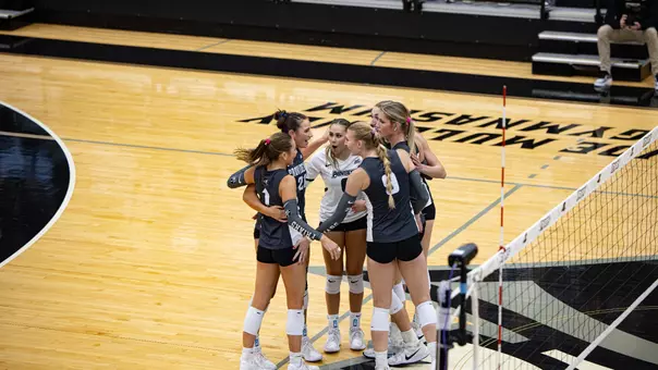 Volleyball vs DePaul team huddle after a point