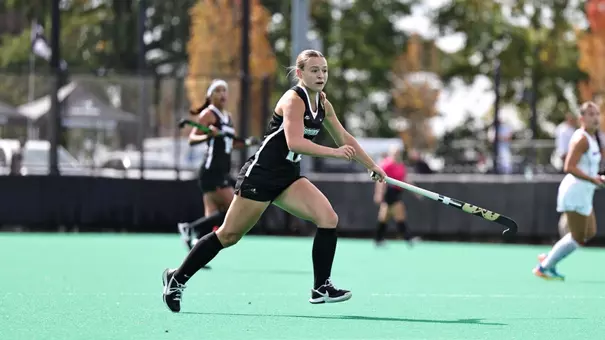 Carly van Benten in game action against UMass Lowell, wearing a black Friars uniform number 12