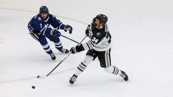 Men's hockey's Logan Sawyer takes a shot against New Hampshire
