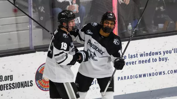 Men's Hockey's Donovan McCoy celebrates with Tanner Adams after scoring a goal against Vermont