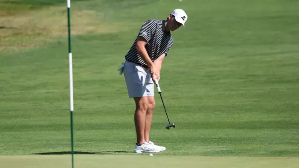 Men's golfer Kevin Legnard hitting a putt