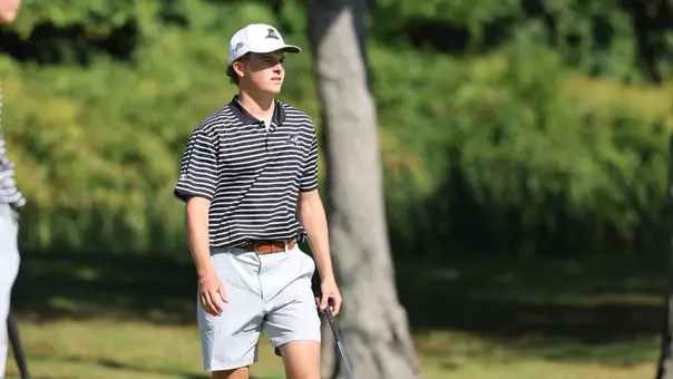 Men's golfer Will Spring walking on the green