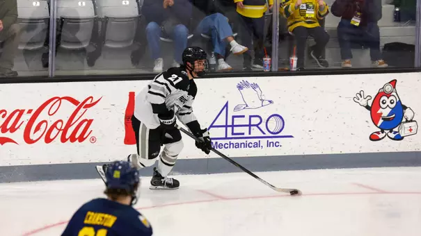 Men's Hockey's John Mustard in action against Merrimack