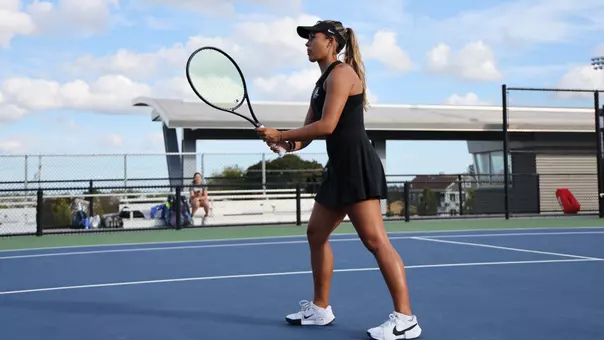 Women's Tennis' Gabriella Plonowski in action against Assumption University
