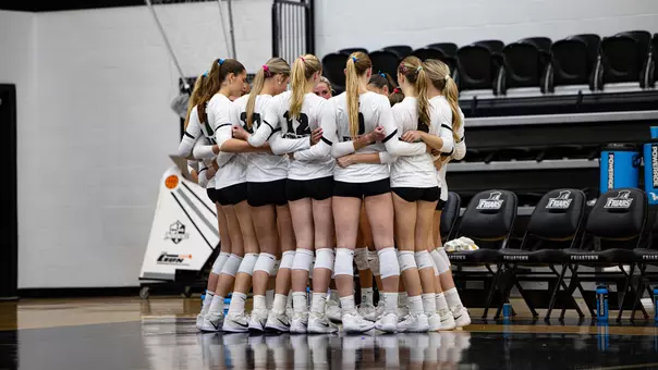 Team huddle against Manhattan in between sets
