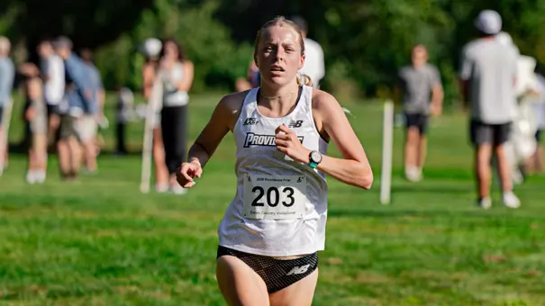 Women's cross country runner Gabby Schmidt running at the Friar Invitational