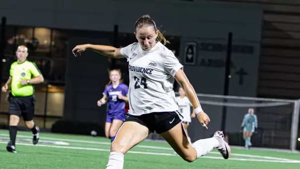 Lily Gibbs kicking ball
