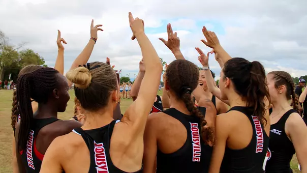 The Louisville women's cross country team huddles before the Southern Showcase