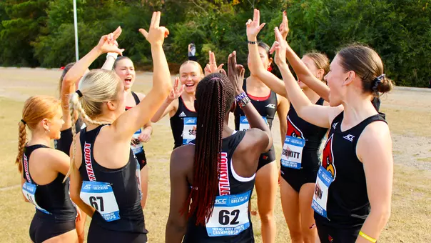 Women's cross country team huddles at the 2024 ACC Cross Country Championships