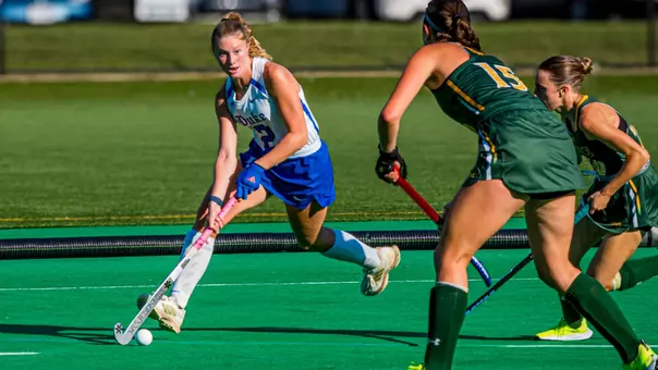 Madison Beach dribbles ball on green turf at William & Mary
