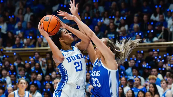 Arianna Roberson takes a contested layup against teammate Taylor Solfikanich in blue vs white scrimmage