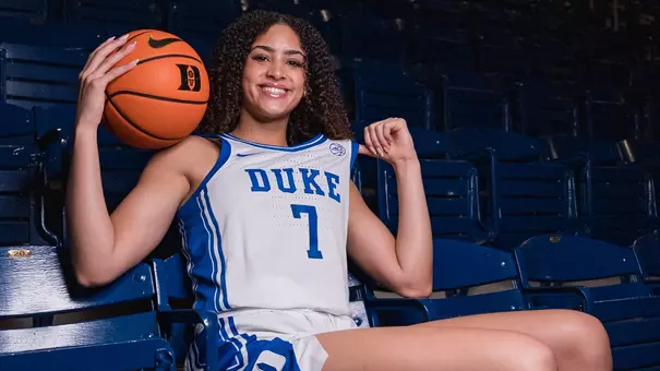 Aaliyah Crump poses on a bench chair in Duke uniform