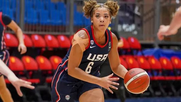 Bella Flemings in USA Basketball Uniform dribbles with her left hand