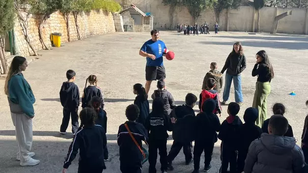 Duke offensive lineman Micah Sahakian participates in a community service project.