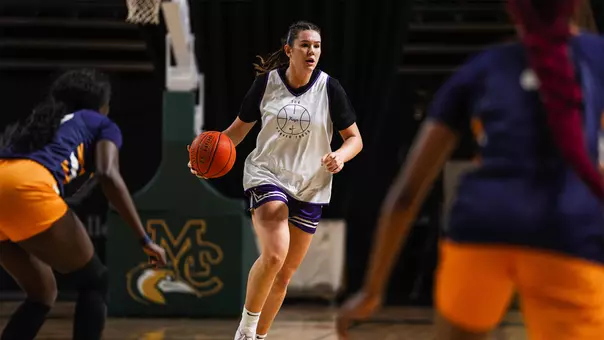 Lara Somfai dribbles in transition wearing a white practice jersey