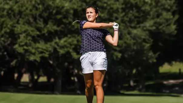 Ella Forss plays a second shot with an iron wearing a black shirt