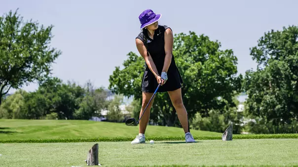 Kirstin Angosta gazes down the fairway as she prepares to hit a tee shot.