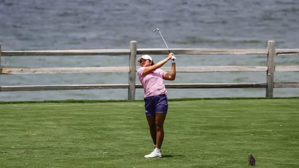 Kirstin Angosta follows through and tracks her ball following a tee shot.