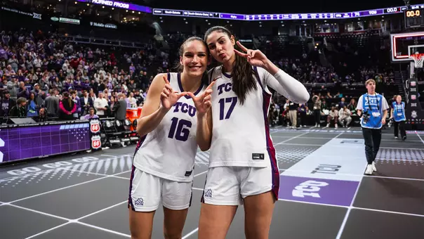 Clara Bielefeld and Clara Silva celebrate following a win in the Big 12 Tournament