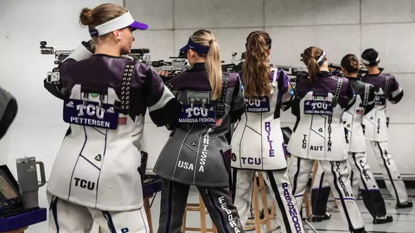 Five members of the TCU rifle team lineup on the firing line.