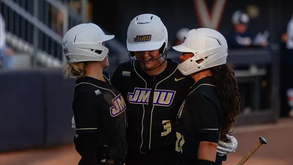 James Madison softball celebrates home runs.