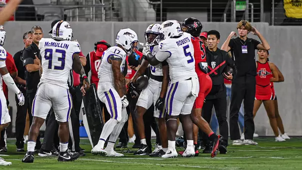 DJ Kelly celebrates with teammates after his interception at San Diego State on Sept. 19.
