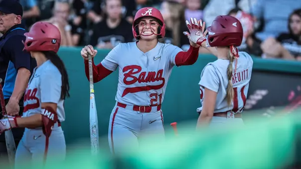Ana Roman (21) high fives Larissa Preuitt (11) vs. West Alabama (Oct. 10, 2025)