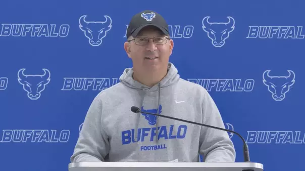 Pete Lembo speaking at a podium