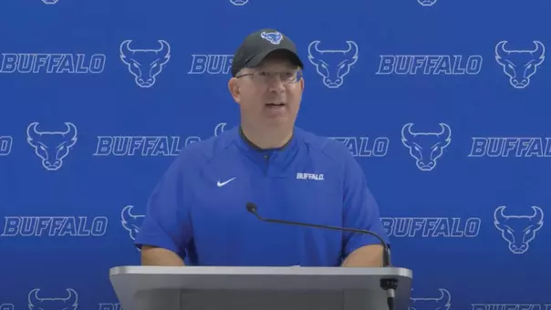 Pete Lembo speaking at a podium