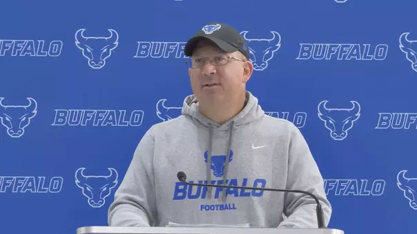 Coach Lembo speaking at a podium