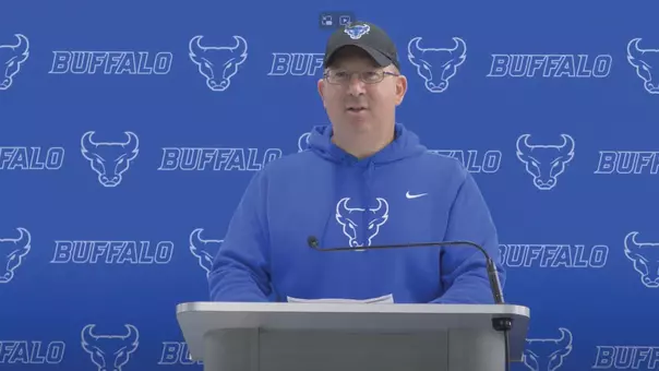 Pete Lembo speaking at a podium