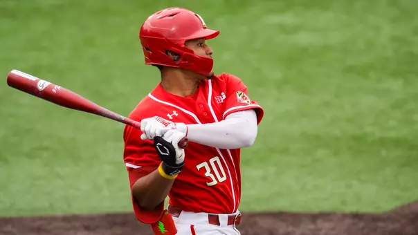 Paul Jones II hitting in a red uniform vs. Purdue