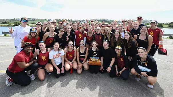 The USC Women's Rowing team poses with the trophy after beating UCLA