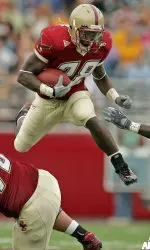 Running back A.J. Brooks leaps over his blocker to gain yardage during the fourth quarter.