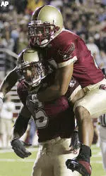 Joel Hazard jumps on the back of Grant Adams (5) after Adams' touchdown in the second quarter.