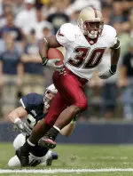 Boston College runningback L.V. Whitworth breaks a tackle from BYU defensive back Quinn Gooch to head down field during the first quarter Saturday.