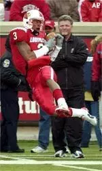 Louisville's J. R. Russell hauls in a pass from quarterback Stefan LeFors during the first half.
