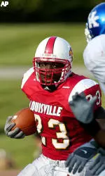 Lionel Gates tries to turn the corner around Kentucky defenders.