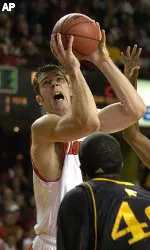 Louisville's David Padgett, left, gets a shot off over the defense of Prairie View A&amp;M's Anthony Oha, center, and Clifford Franks, right, during first half action Saturday, Dec. 3, 2005 at Freedom Hall in Louisville, Ky. (AP Photo/Timothy D. Easley)