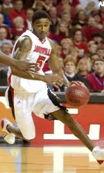 Dean drives around Cincinnati's Jason Maxiell during the second half of Louisville's 77-70 win.