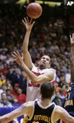 Francisco Garcia shoots over West Virginia's Kevin Pittsnogle in Saturday's Albuquerque Regional Final.