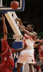 Louisville's Brandon Jenkins, center, passes over South Carolina's Renaldo Balkman, left, and Tre' Kelley in the first half. (AP Photo/Julie Jacobson)